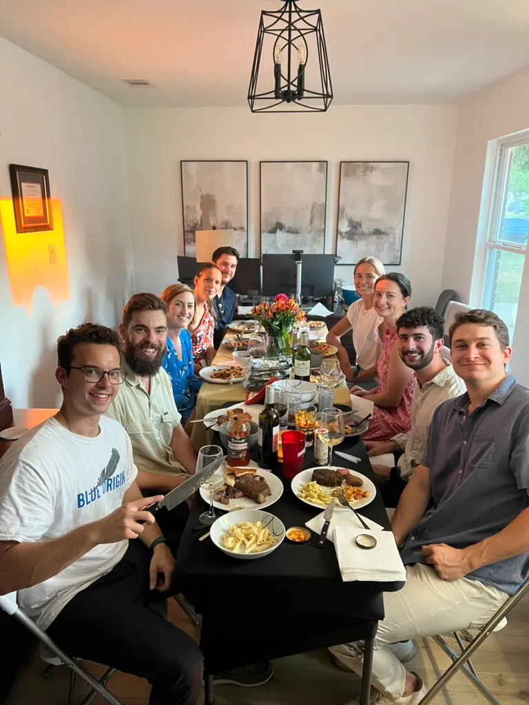 A dinner party with friends around a full table
