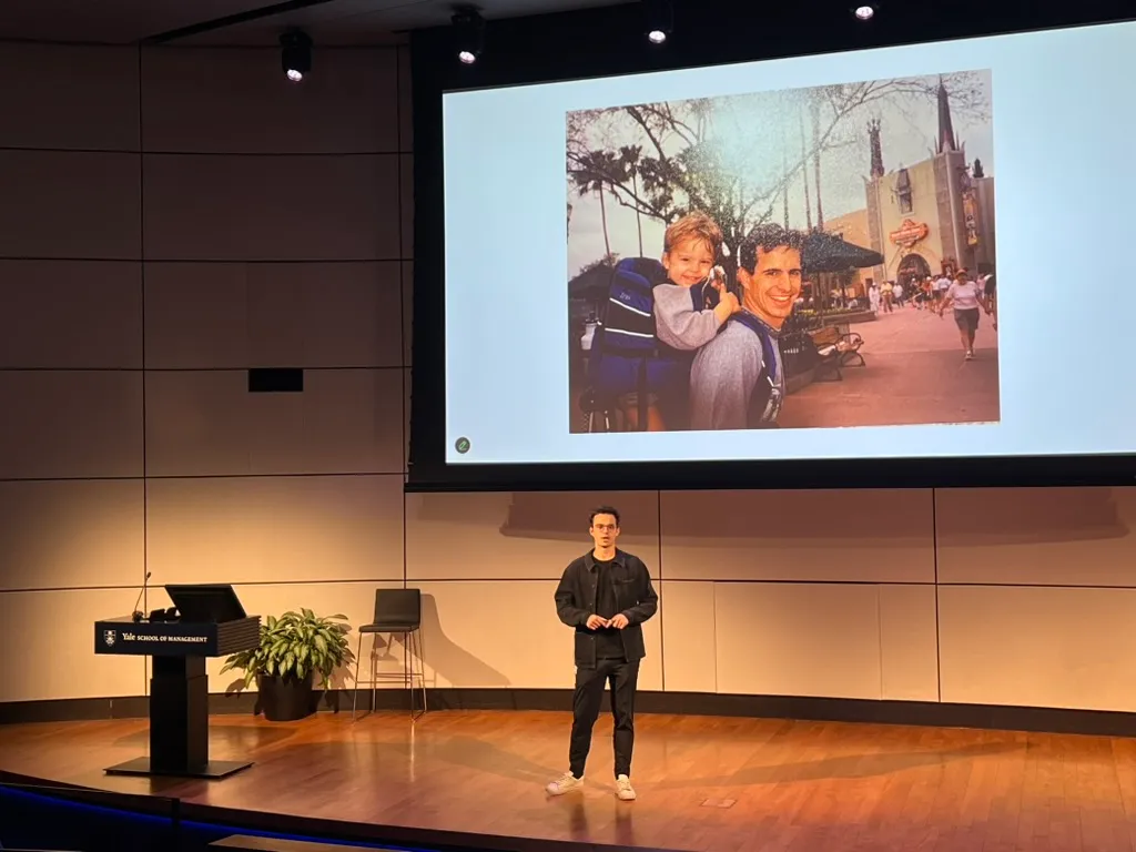 Speaking on stage at the Yale School of Management